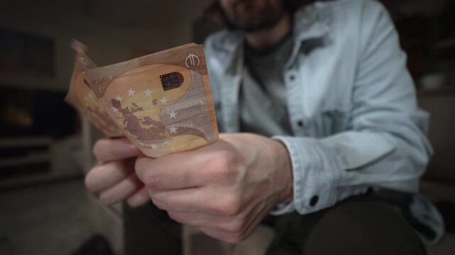Man counting euro banknotes in hand closeup. Cash fanning and counting money concept for income profit wealth and financial success. Man Counting Cash Euros