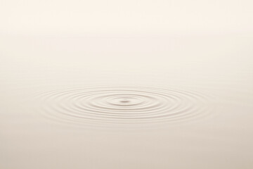 Fototapeta premium Minimalist Water Ripple on Cream Surface Representing Calm and Serenity