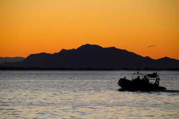 Motorboat sailing at sunset in Santa Pola coast