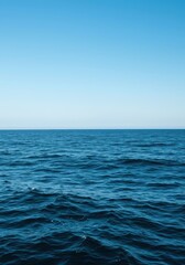 Obraz premium Expansive deep blue ocean waves stretching toward the endless horizon under a bright clear sky, symbolizing travel, freedom, and marine vastness, sky, ocean, hydrospace