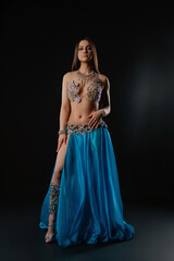 Obraz premium Woman dances with a snake in a dark setting at a cultural event
