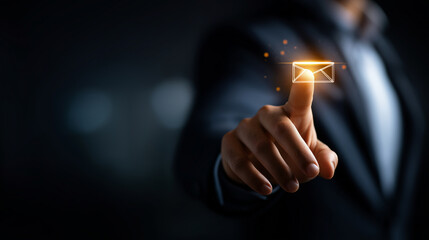 Faceless finger pressing glowing icon of email envelope heavily defocused background anonymous hand representing digital communication contact options in modern interface