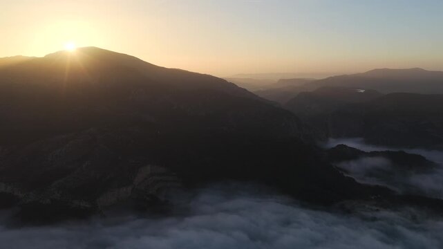 Aerial Sunrise Above the Clouds at Caminito del Rey, Guadalhorce Lake, and the Pine Forests of Andalusia, Spain