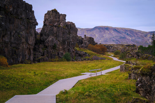 Volcanic rock formations and towering basalt walls at the &Ouml;xar&aacute;rfoss waterfalls in Thingvellir National Park in Iceland