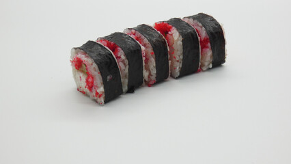 Sushi rolls arranged neatly on a white surface with various ingredients and textures visible