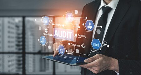 A businessman utilizes a tablet to perform a digital audit, showcasing various compliance and analysis graphics in a modern office setting with innovative technology. Tessel