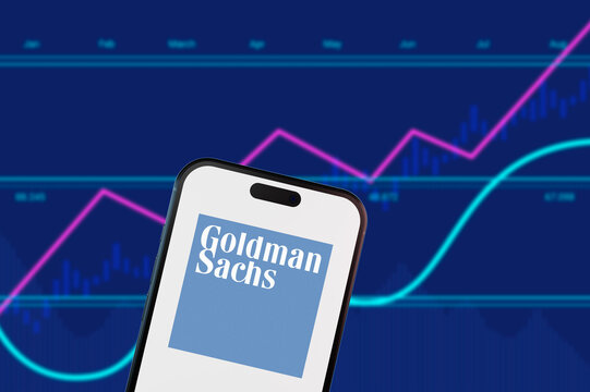 Perrysburgh,Ohio,USA-January 12 2025: Goldman Sachs logo on a smartphone with stock market charts. Concept for investment banking, asset management, and financial trading