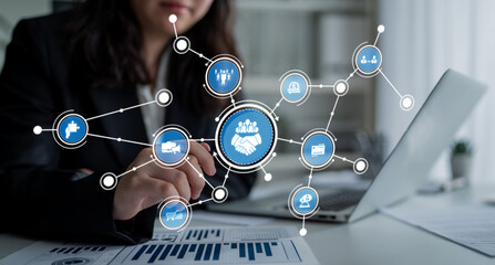 A business professional interacts with a digital handshake icon representing partnership, showcasing the importance of teamwork and collaboration in corporate success. Crux