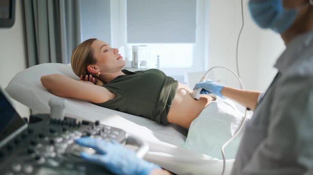 Mother having sonogram examination closeup. Doctor using ultrasound machine