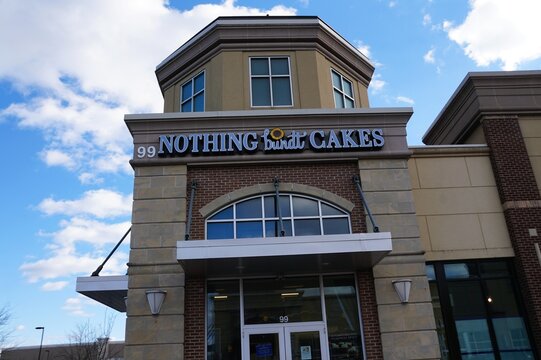 Collegeville, Pennsylvania, U.S - Dec 6, 2025 - Nothing Bundt Cakes bakery storefront with seasonal pumpkin spice promotion and stylized branding featuring sunflower graphic