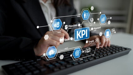 Hands engage with a keyboard showcasing KPI graphics, emphasizing goals, objectives, and alignment, ideal for business analysis, reporting, and strategy development. Tessel