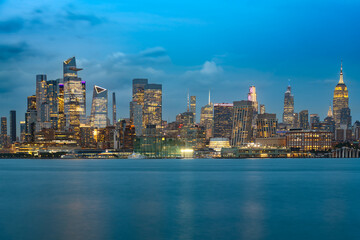 The New York City skyline at dusk, showcasing the concentration of high rise buildings in Midtown and the Hudson Yards area.