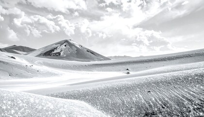 Monochromatic landscape showing snowy dunes and a conical mountain beneath a cloudy sky