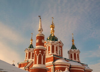 Bright domes, towers and golden crosses of an Orthodox church against a blue sky background