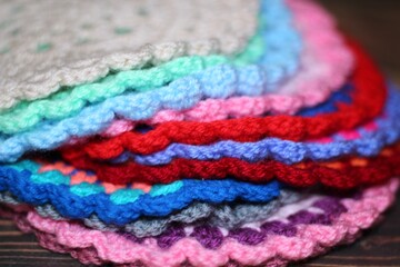 Crocheted mandala doily on wooden background handmade decor art craft photo	