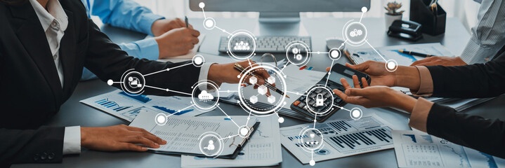 Business Team Collaborating with Digital Technology and Data Analysis Tools in Modern Office Environment. Amity