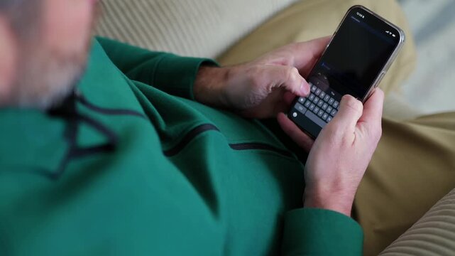 Middle Aged Man Receives an Attractive Remote Job Opportunity - SMS Text Scam to Credential Data Harvesting - Cybersecurity Education Concept