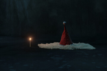 3D rendering of a Christmas hat lying on a fluffy rug illuminated by candle light