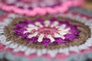 Crocheted mandala doily on wooden background handmade decor art craft photo	