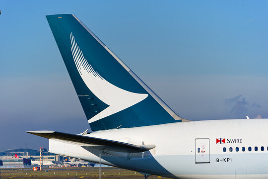 Cathay Pacific passenger airplane Boeing 777-300ER registration B-KPI pulled by aircraft tug at German Frankfurt Airport on a sunny autumn day. Photo taken November 22nd, 2025, Frankfurt am Main, Germ