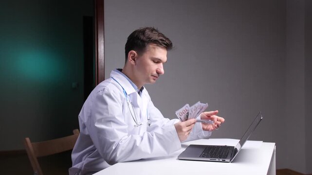 Doctor in medical gown sits at white desk counting hundred dollar bills, symbolizing healthcare costs, medical expenses, private practice income and financial pressures in medicine