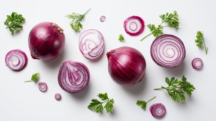 Overhead shot of red onions, cut into various shapes, scattered with sprigs of green herbs on a white background