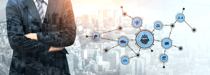 A businessman stands confidently in front of a cityscape, showcasing a digital network with various connection icons, symbolizing modern business concepts and collaboration. Tessel