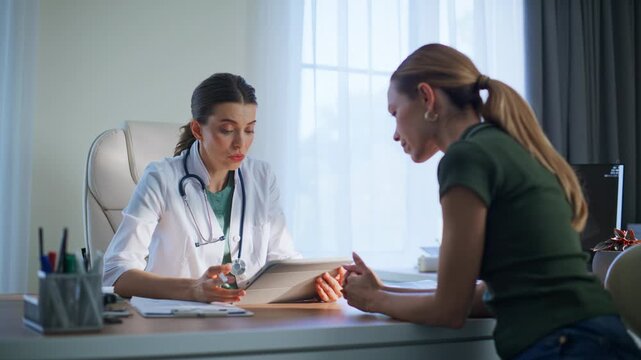 Medic showing tablet tests result explaining diagnosis patient in clinic closeup