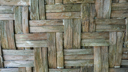 Aged hand-woven bamboo wall panel with natural weathered texture