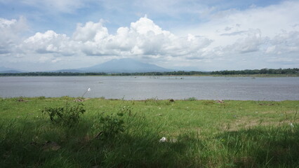 Scenic view of freshwater aquaculture nets and small huts on a reservoir in Indonesia