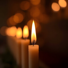 Warm candlelight flickers in dark room with blurred background lights