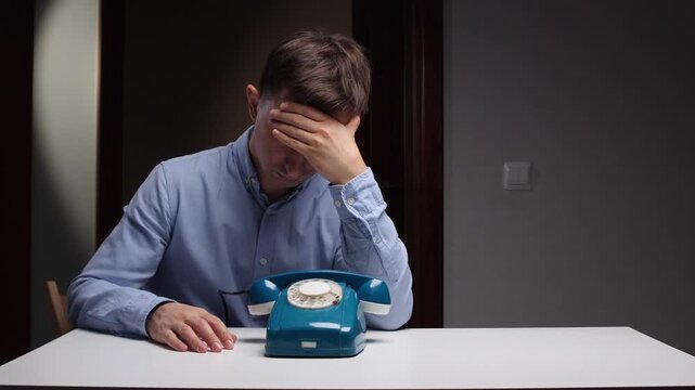 Quiet man sleeping, Man dozing beside antique phone, Man rests quietly near oldfashioned telephone on table, Peaceful man leans with closed eyes adjacent to antique telephone on table surface