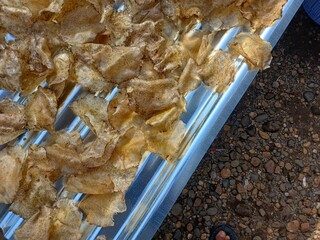 Drying raw Jengkol crackers in The Yard