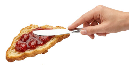 Hand spreading jam on toasted bread
