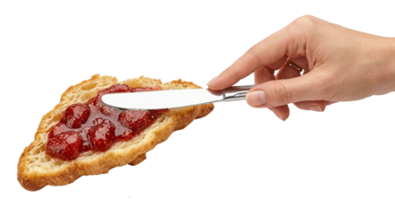 Hand spreading jam on toasted bread