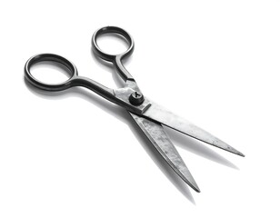 Obraz premium Open metal scissors cast a shadow on a white background, showing their aged texture and rounded handle design