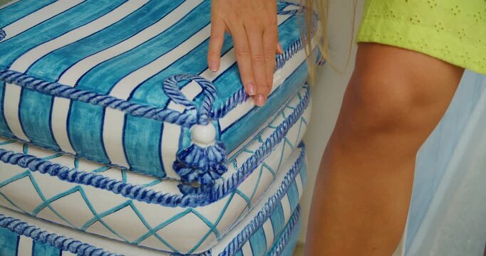 Hand touching ceramic stool with blue nautical pattern