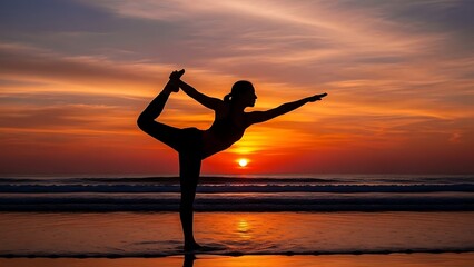 Silhouette of a woman performing yoga on a beach at sunset.
