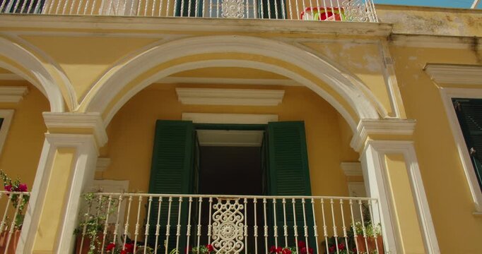 Yellow villa with arches and shuttered windows in Via Camerelle Capri Italy on summer day
