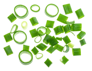 Freshly chopped green onions, a culinary staple, isolated on a stark black background
