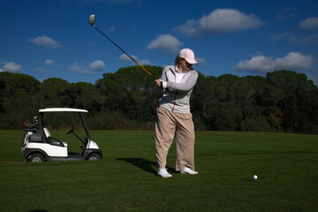 woman playing golf in the green fairway club