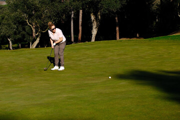 woman playing golf in the green fairway club