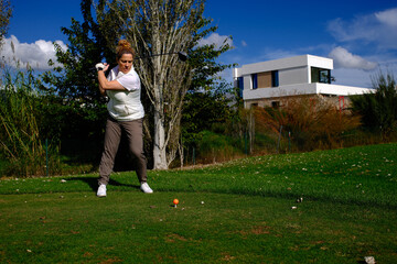 woman playing golf in the green fairway club