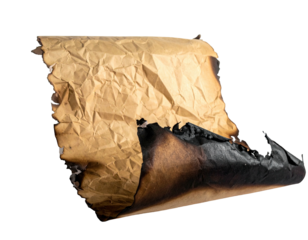 A close-up shot of a burnt and crumpled piece of brown paper on a black background