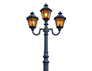 Ornate triple-lamp streetlight illuminated against a stark, black background