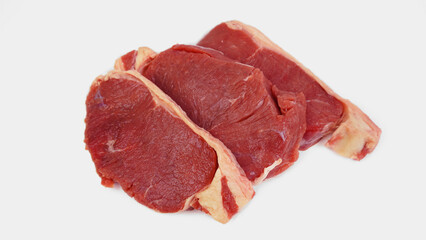 Obraz premium three piles of raw and fresh sirloin beef, raw, uncooked, isolated on white background