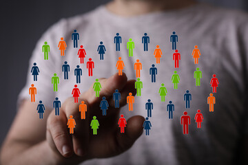 Diverse group of people connected digitally, hand touching network of individuals, representing community and technology.