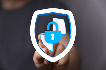Hand pressing a digital security shield with a lock, symbolizing protection, privacy, and cybersecurity in modern internet
