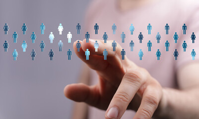 A hand touching digital human icons representing connection, teamwork, and the concept of a network or community