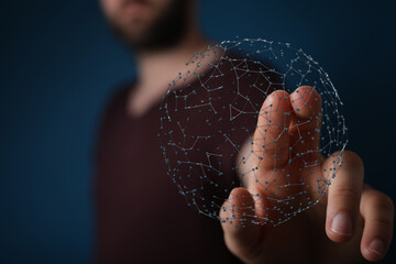 Person interacting with a futuristic digital network sphere, representing global connection, technology, and data transfer.